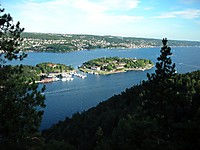 Vi fikk øye på nordre og søndre Kaholmen, en kan se Oscarsborg festning (bygd 1643) på sørøya. Her ved Drøbaksundet senket oberst Birger Eriksen den tyske krysseren Blücher i 1940, 1000 mann omkom i fjorden. Vraket ligger fortsatt på bunn og utgjør en miljøtrussel for fiskelivet i Indre Oslofjord.