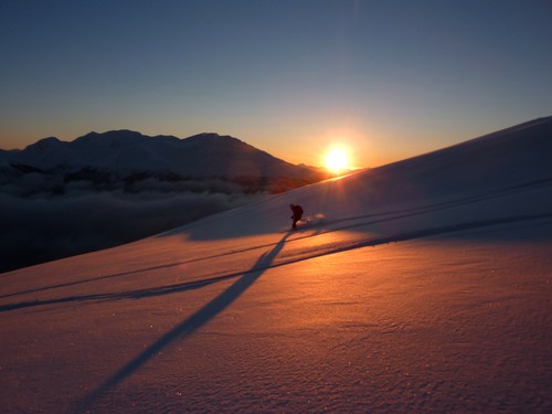 Kristin flying down beautiful snow-covered slopes against low-angled January sunshine