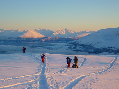 Kamila approaching us on the skitopp, view southeast towards Andersdalen on the mainland