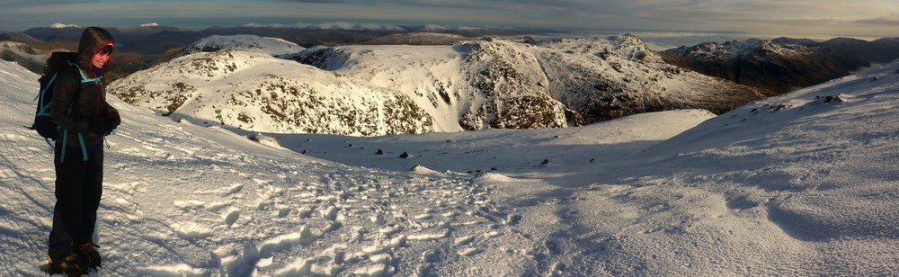 Sue on the top of Scafell Pike, with a view towards Esk Pike and Bow Fell in the background