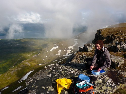 Jen enjoying an atmospheric and sunlit lunch on Bakaromntinden